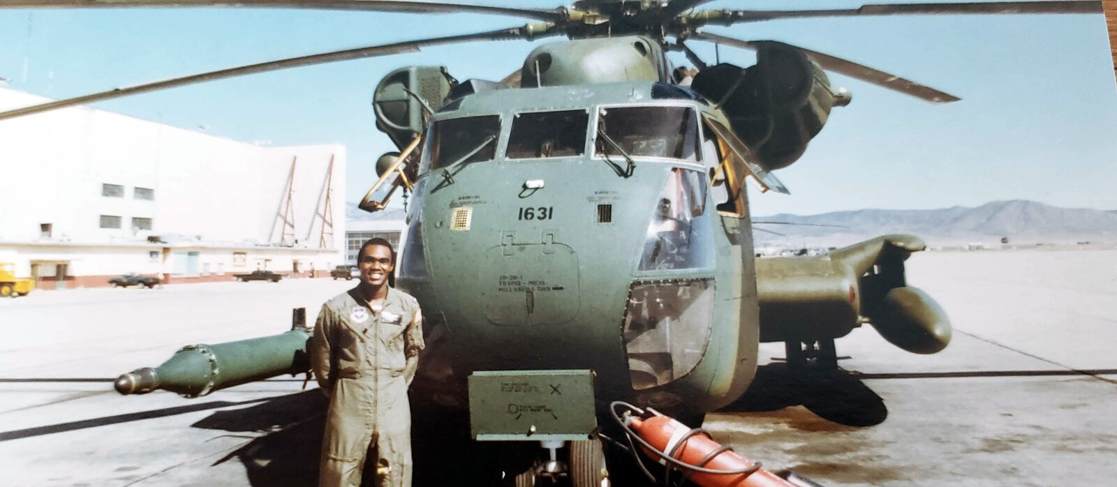 Donald Mitchell standing beside the nose of MH-53J Pave Low helicopter 1631 at Kirtland Air Force Base, Albuquerque, New Mexico.